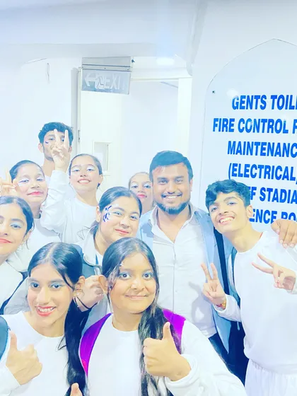 A happy selfie with a group of students backstage. The energy and excitement of school events are contagious.