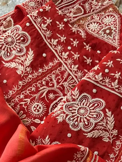 A bold and beautiful Sindoori Red silk chanderi suit. This piece features heavy Chikankari work embellished with sequins and seed pearls.