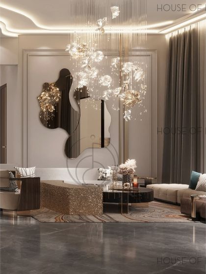 We wanted this living room to feel like a pause. The space is soft and glowy, with a floral-inspired chandelier, an artistic mirror, and a mix of metallic and textured furniture that invites you to sit down and stay awhile.