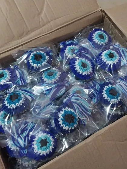 A closer look inside the box of 100 evil eye keychains. Seeing this fills me with so much joy.