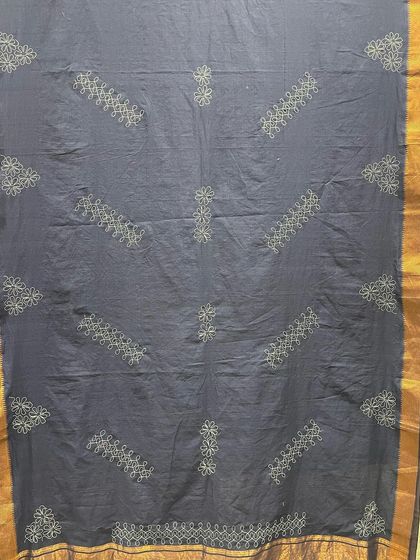 This custom-made Mangalgiri saree showcases a blend of cultures with Indo-Japanese Sashiko embroidery. The geometric running stitches create a subtle, elegant pattern against the deep blue cotton, with a traditional golden border.