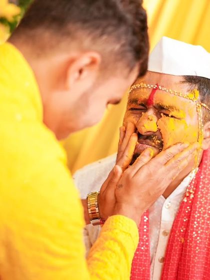 A close-up of the groom during the Haldi ritual, a moment of both fun and tradition.