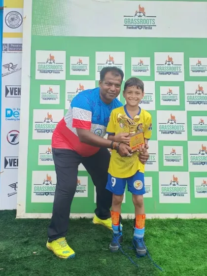 A player from our U11 championship team receives his individual medal at the Grassroots Football Fiesta.