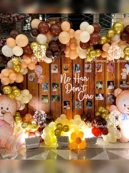 I love adding a touch of humor and personality to traditional ceremonies. This "No Hair Don't Care" photo wall for a Mundan ceremony uses a warm, wood-paneled backdrop, earthy-toned balloons, and adorable teddy bears to create a fun and memorable photo opportunity.