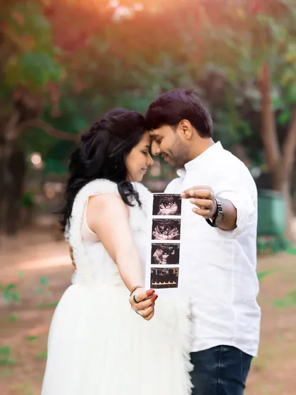 The first glimpse of your little one. This intimate outdoor portrait of an expecting couple holding their sonogram is a beautiful way to announce and celebrate your pregnancy.