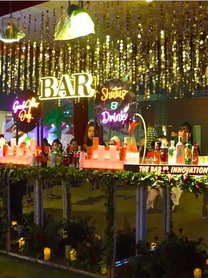 A great bar is the heart of any celebration. We designed and managed this stylish outdoor bar, complete with custom neon signs, an illuminated counter, and glittering overhead decor, ensuring the drinks and the good vibes kept flowing all night.