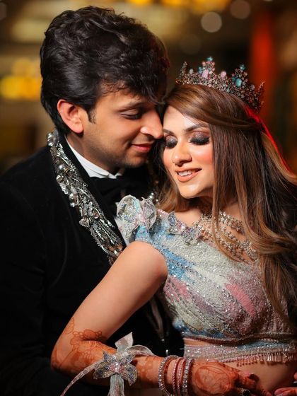 A romantic, colorful portrait of the couple in their fairytale reception attire, complete with a crown for the bride.