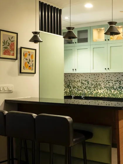 This peninsula kitchen uses a playful mosaic tile backsplash to add a pop of color and personality. The bar seating makes it a great spot for casual meals and morning coffee.