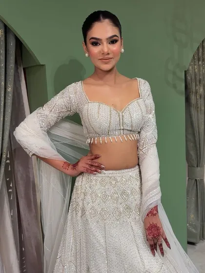 A soft and glam look in a stunning all-white lehenga. This image shows the full outfit, perfect for a daytime engagement or a chic evening reception.