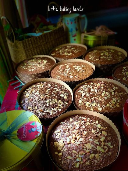 A beautiful batch of my non-alcoholic plum cakes, surrounded by festive gift tins. The kitchen smells absolutely wonderful.