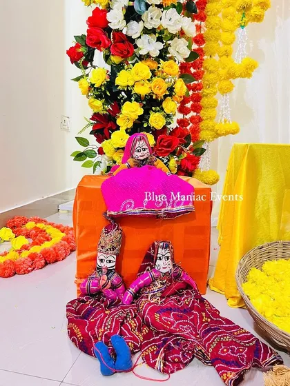 A close-up of the traditional Rajasthani puppets used as props in the Haldi setup, adding a unique cultural touch.