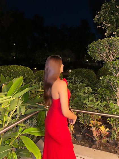 A side profile of the red dress, showing off my hair and the elegant silhouette of the dress.