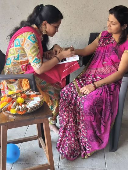 A candid moment from the Ram Mandir celebration event, where I am applying a festive design for a client.