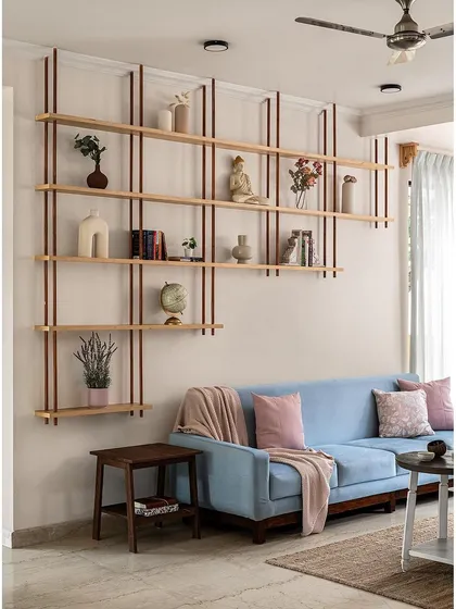 To make use of a large blank wall in this living room, I designed this open shelving unit. It serves as a beautiful focal point for displaying personal decor while maintaining a light and airy feel.
