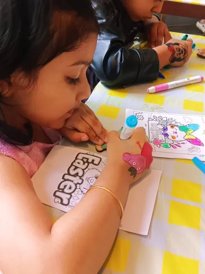 Another happy artist at the party, working on both her Easter-themed coloring sheet and a wooden magnet. It's all about providing options to keep everyone happy.