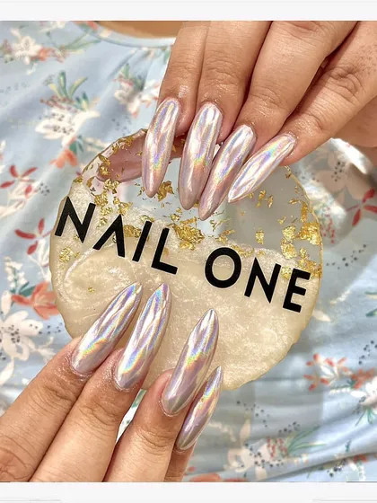 This is where nail art becomes a statement. We sculpted these long, almond-shaped acrylic extensions and finished them with a mesmerizing holographic chrome powder that catches the light from every angle. This look is for those who want their nails to be the center of attention.