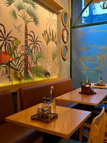 A cozy corner in my Rajouri Garden café, with beautiful wall art and comfortable seating. Perfect for a quiet afternoon.