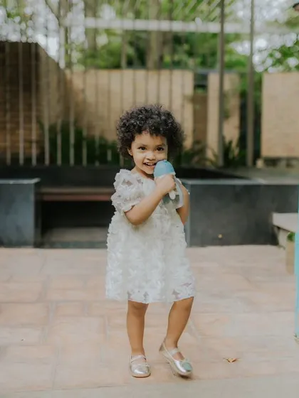 I'm just good with my sipper. An outdoor shot of a toddler enjoying a summer day.