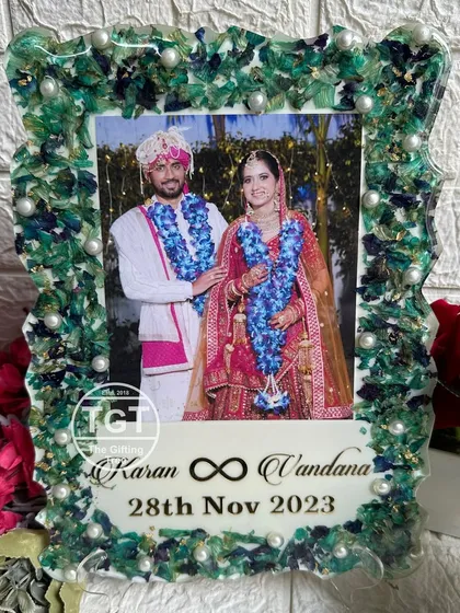 A clear, frontal shot of the frame, showing the infinity symbol between the couple's names.