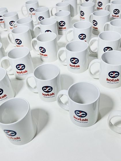 A large batch of classic white ceramic mugs, custom printed for Kotak Mutual Fund. We can produce high volumes of branded merchandise for large corporate orders.