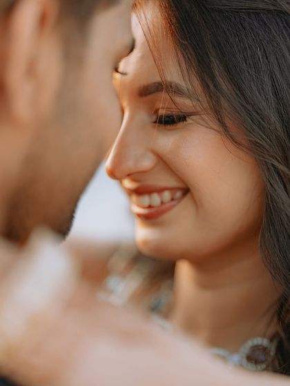 Another angle of the same intimate moment, capturing the bride's joyful expression as she looks at her partner.