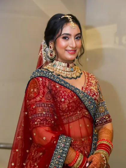 A smiling portrait of the bride, looking confident and radiant. The makeup is a perfect balance of glam and elegance.