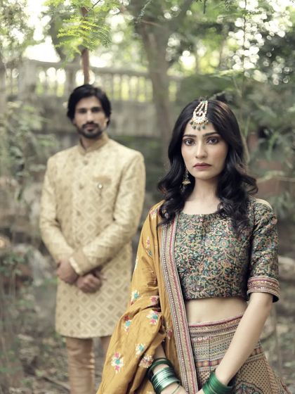 This earthy-toned printed lehenga paired with a simple groom's kurta is perfect for a rustic or bohemian-themed pre-wedding shoot.