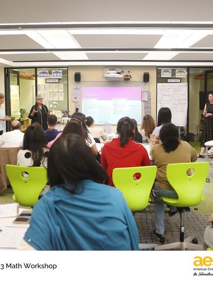 Parents listen as teachers explain the goals of the math workshop. These sessions empower parents with strategies to support their children at home.