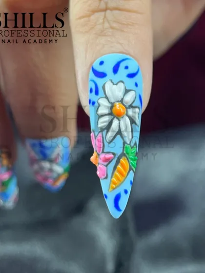 This detailed Easter-themed nail art features 3D sculpted bunnies, carrots, and flowers on a bright blue base.