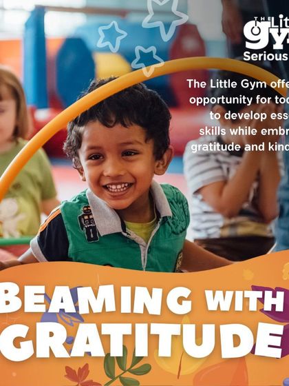 A young boy smiles brightly while playing with a hula hoop. My program offers toddlers a chance to develop essential skills while embracing gratitude and kindness in a group setting.