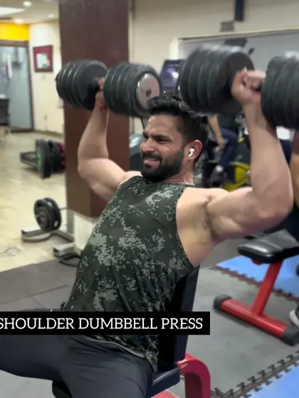 Day 28: Performing a shoulder dumbbell press to build upper body strength and size.