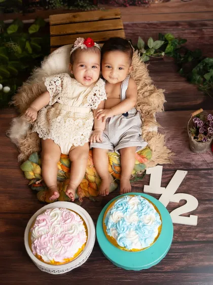 A sweet portrait of the twins sitting together after their messy celebration. This shot captures their special bond on their six month milestone.