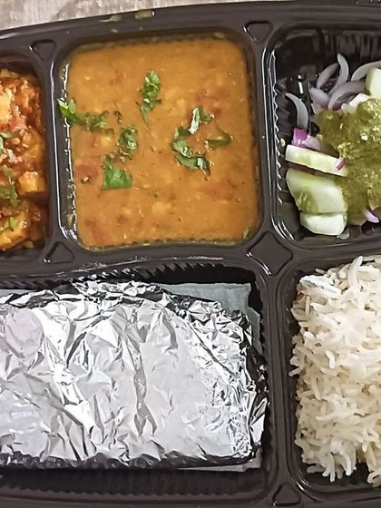 A simple and healthy thali with dal, arbi sabzi, rice, and roti. This is a perfect example of a light, home-cooked meal.