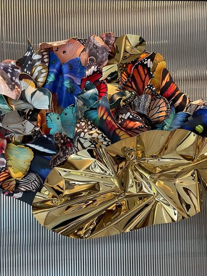 Another angle of "Emphemeral Reflections," highlighting the texture of the background and the sculpture's reflective qualities.