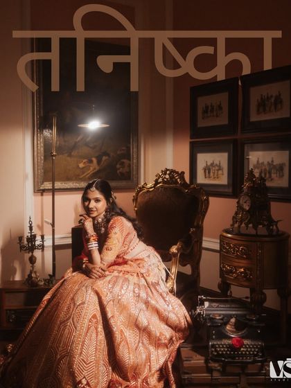 A regal portrait of Tanishqa, seated like a queen in a vintage setting. The composition and lighting give this image a classic, painterly quality, celebrating her grace and the grandeur of the day.