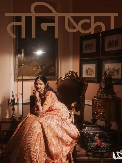 A regal portrait of Tanishqa, seated like a queen in a vintage setting. The composition and lighting give this image a classic, painterly quality, celebrating her grace and the grandeur of the day.