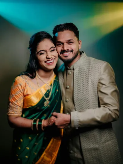 A joyful and vibrant portrait from a studio engagement session. The couple's bright smiles and the dynamic lighting create an energetic and happy image.