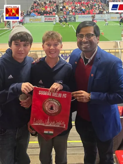 Sharing the Sudeva spirit. Mr. Gupta presents a club pennant to young fans in Germany, creating lasting memories and friendships.