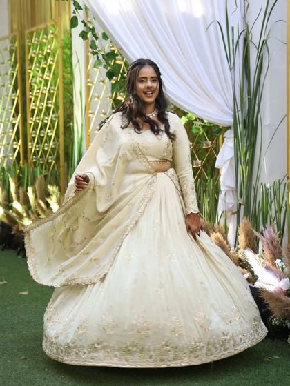 Elegance meets happiness in every twirl. Our lovely client Jiya looks absolutely radiant in this custom-made ivory and gold lehenga, perfect for any grand celebration.