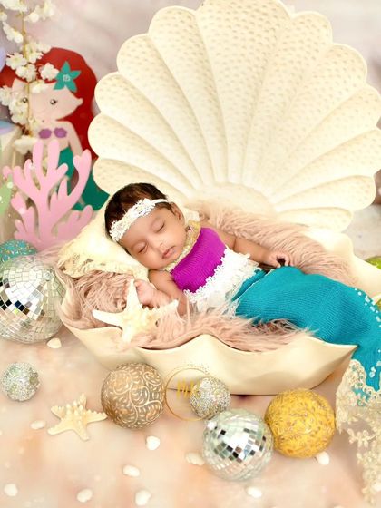 Another angle of the mermaid-themed newborn shoot, showing more of the colorful and detailed "under the sea" props.