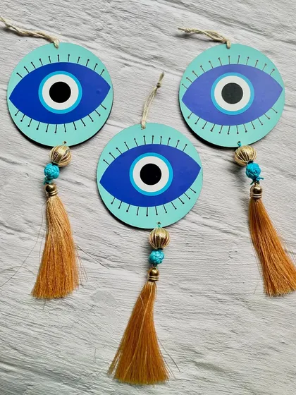 A set of three evil eye hangings, ready to be shipped to a client. They can be hung on a wall, door, or in a car.