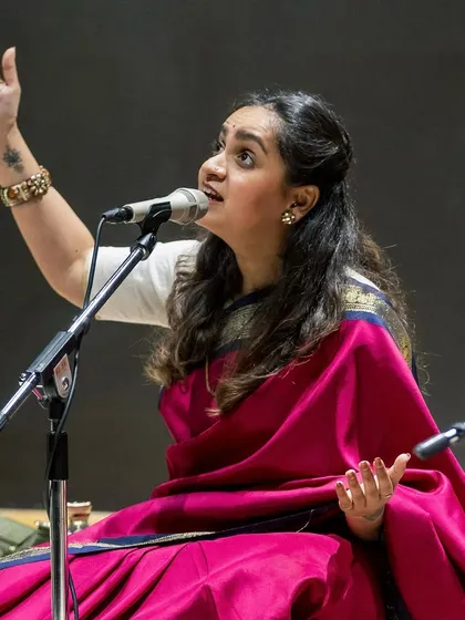 In a traditional Carnatic concert setting, I feel deeply connected to my roots. Dressed in a saree, seated on stage, I share the classical music that was my first language, a pure and soulful experience with my audience.
