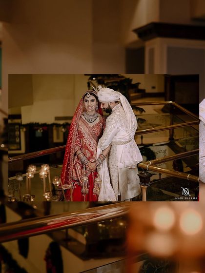 A creative composition looking down a staircase, with an inset of the couple's portrait. It adds an interesting perspective and artistic flair to the wedding album.