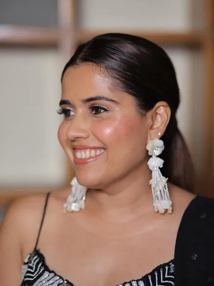 A beautiful, happy client. Her smile says it all. The makeup is fresh and radiant, perfect for celebrating a special day.
