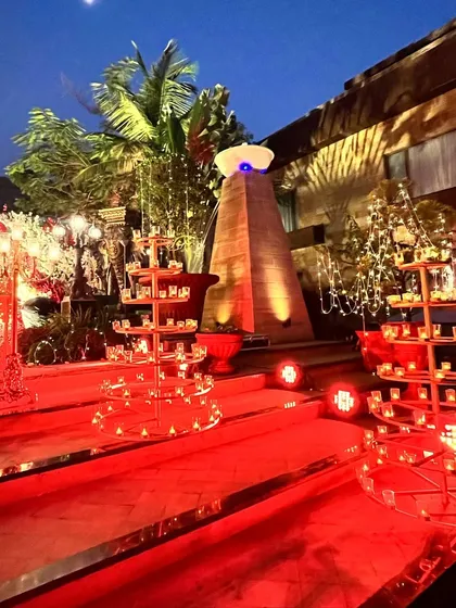 The venue entrance lit up for the night. The use of fairy lights and candle stands creates a warm and inviting welcome for guests.