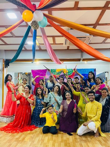 The whole group posing with their dandiya sticks. The joy and community spirit during our festival celebrations are what make Quadz special.