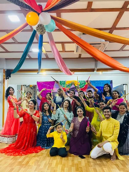 The whole group posing with their dandiya sticks. The joy and community spirit during our festival celebrations are what make Quadz special.