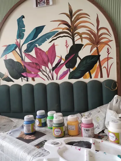 A shot of my paint palette and supplies in front of the partially completed tropical mural, giving a glimpse into the colors used.