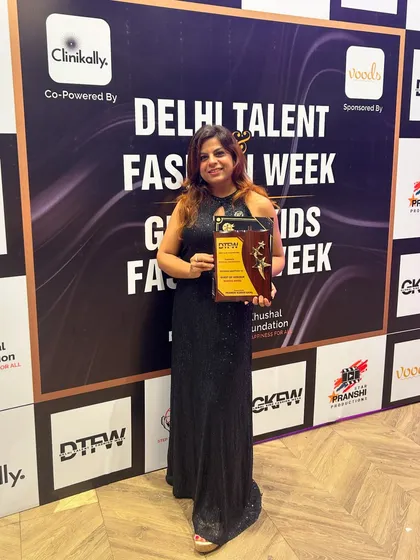 A jury member proudly holds her award in front of the media wall. We ensure that photos of our special guests and judges also highlight the brands that make our events possible.