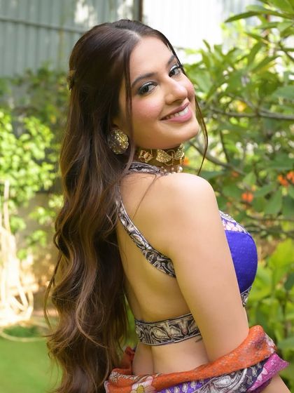 A bright, smiling portrait that captures the fun and vibrant energy of a mehendi event.